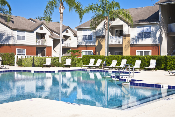 Condominium complex with swimming pool, palm trees